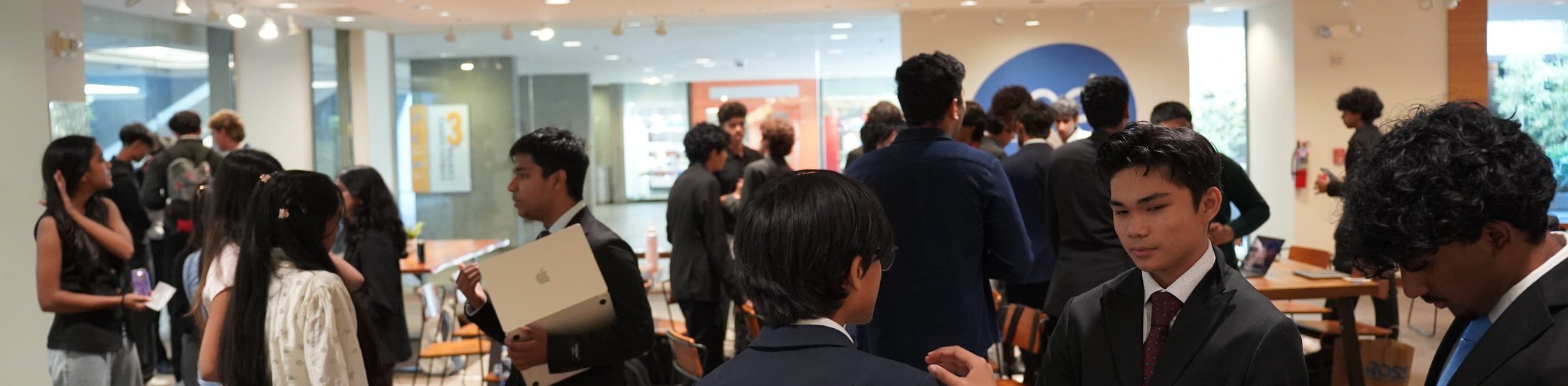 Attendees networking across a full room before the programme starts